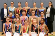 In drei Reihen präsentieren sich die Gymnastinnen mit ihren Medaillen